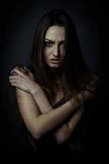 Close up portrait of a sad woman with crossed hands