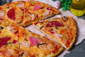 close-up Delicious Meat Pizza with Ham, Bacon and sausages on the wooden background