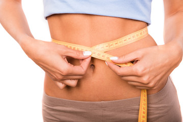 Close up photo of girl measuring the waist with a measuring tape