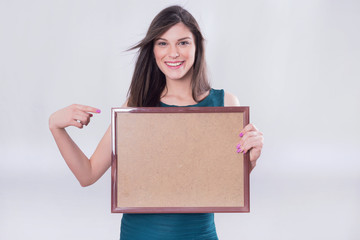 Girl pointing at a wooden board 