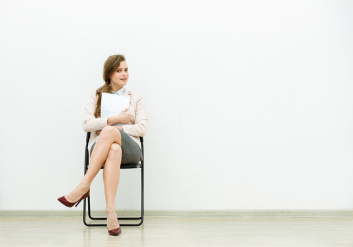 Woman In Office Outfit Waiting On A Chair