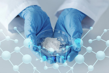 close up of scientist holding petri dish in lab