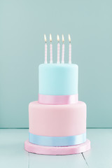 Fondant covered pastels coloured birthday cake with five birthday candles