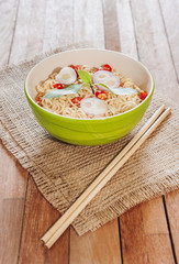 Noodle in bowl on wooden background