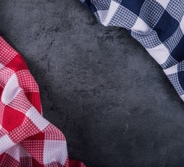 Top view of checkered kitchen tablecloth on granite -  concrete - stone background. Free space for...