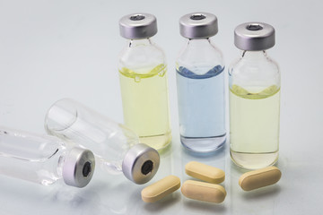 Medical vials for injection with yellow pills, isolate
