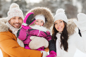 happy family waving hands outdoors in winter