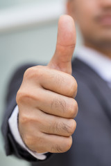 Asian businessman showing thumb up