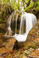 Naklejka na ściany i meble Silky water flowing down a stream Plitvice national park in Croatia, a UNESCO world heritage site