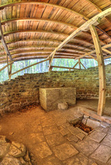 Ruins of an ancient fortress covered with wooden roof in fish-eye perspective