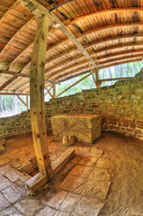 Ruins of an ancient fortress covered with wooden roof in fish-eye perspective