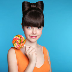 Smiling teen girl with colourful lollipop. Attractive Funny brun