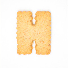 letter H made of cracker cookie isolated on white background.
