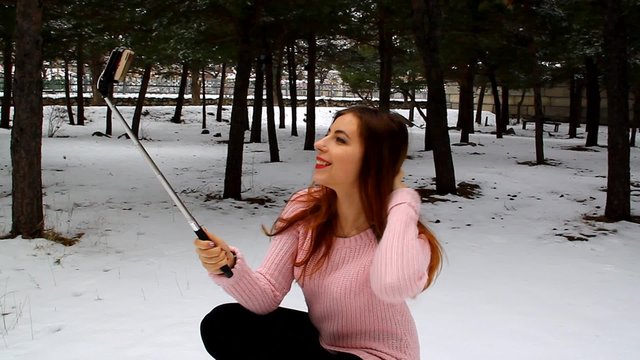 Young girl selfe on the phone in the park outdoors