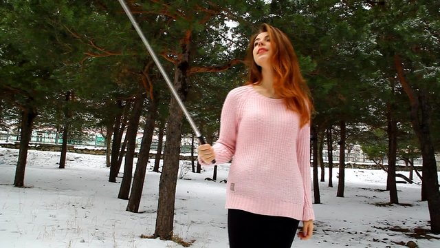 Young girl selfe on the phone in the park outdoors