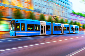 Modern tram on city street in Stockholm, Sweden