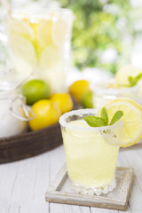 Refreshing lemonade on a rustic outdoor table in bright light