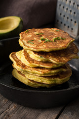 Stack of homemade savory vegetable pancakes / cabbage pancakes / zucchini pancakes / vegetable fritters with cheese. Natural light, selective focus