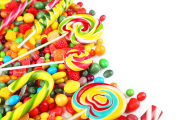 Different fruit candies on white background