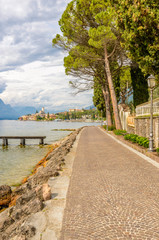 Walkpath along beautiful peaceful lake Garda, Italy