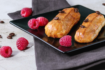 Coffe eclair with raspberries
