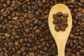 wooden spoon on coffee beans background