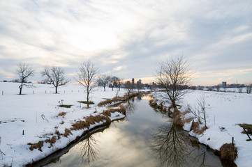 Creek Flowing through Snowy Field
