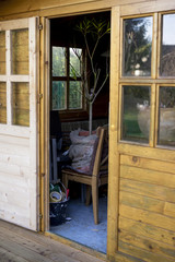 Open door into a wooden storage shed