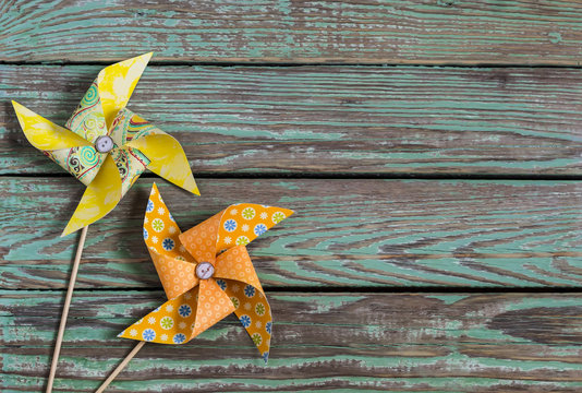 Homemade paper pinwheel on a wooden rustic background . Vintage and rustic style