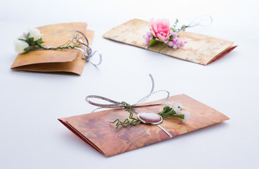 Hand made invitation with interesting decorations over grey background