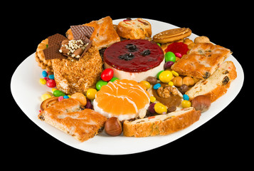 Image of various tasty cookies on the plate closeup