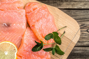 Fresh salmon fillets on wood, selective focus.
