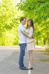 Hugging couple smiling side view