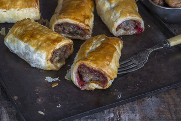 Homemade pork sausage rolls with chestnuts, cranberry sauce and sage