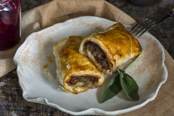 Homemade pork sausage rolls with chestnuts, cranberry sauce and sage