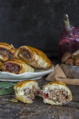 Homemade pork sausage rolls with chestnuts, cranberry sauce and sage