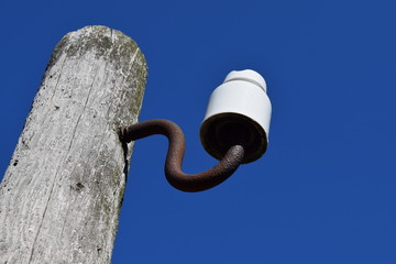 Wooden pole with an insulator