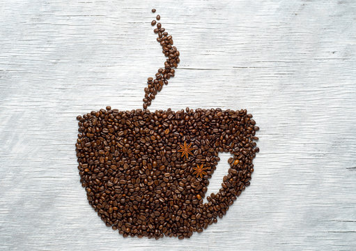 Picture a cup of coffee made from beans on the board