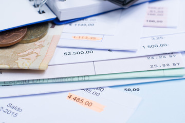 Mortgage and utility bills, coins and banknote, calculator