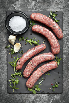 Raw Sausages on Slate Overhead View