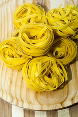 Italian noodle nest on wooden