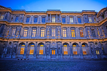 Obraz premium Paris, France, February 6, 2016: exterior of Louvre, the well-known residence of the French kings, nowadays - one of the largest museums of the fine arts in the world, Paris, France