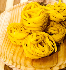 Italian noodle nest on wooden