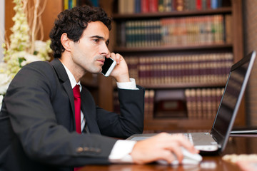 Portrait of an handsome businessman talking on the phone