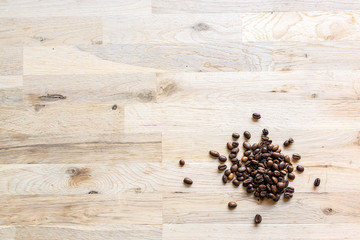 roasted coffee grain on a raw oak table