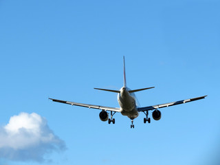 Fototapeta na wymiar airplane taking off, against blue sky