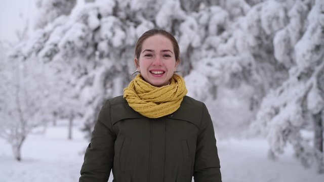 Beautiful woman takes off her hat and throws it into the camera.