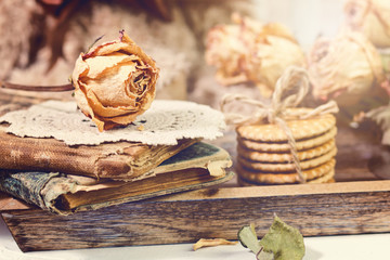 Vintage old books, roses and cup of coffee