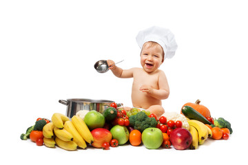 Baby boy in chef hat with cooking pan and vegetables