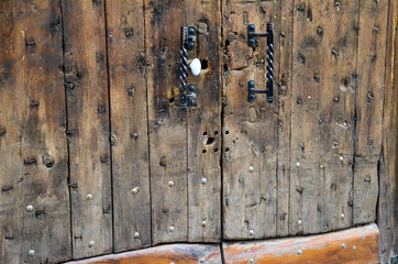 old wooden door with forged handle